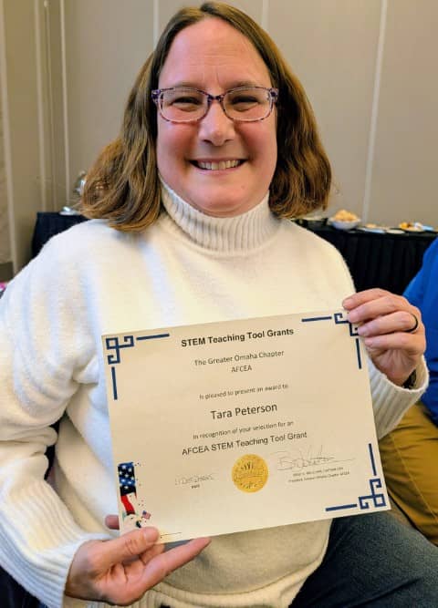 Tara Petersen holding her AFCEA STEM Teaching Tool Grant certificate