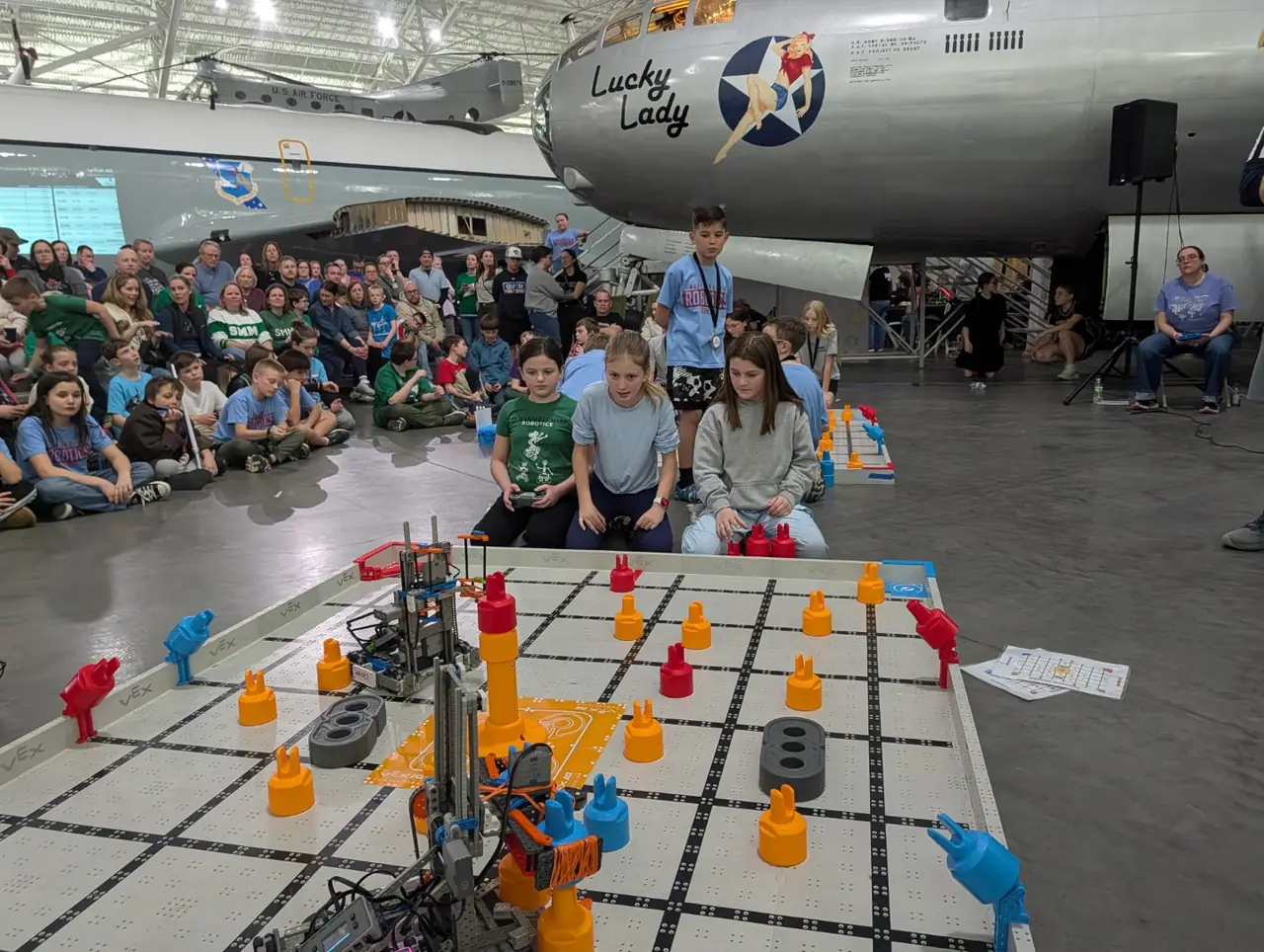 Students driving robots before a crowd at a Nebraska VEX IQ state championship