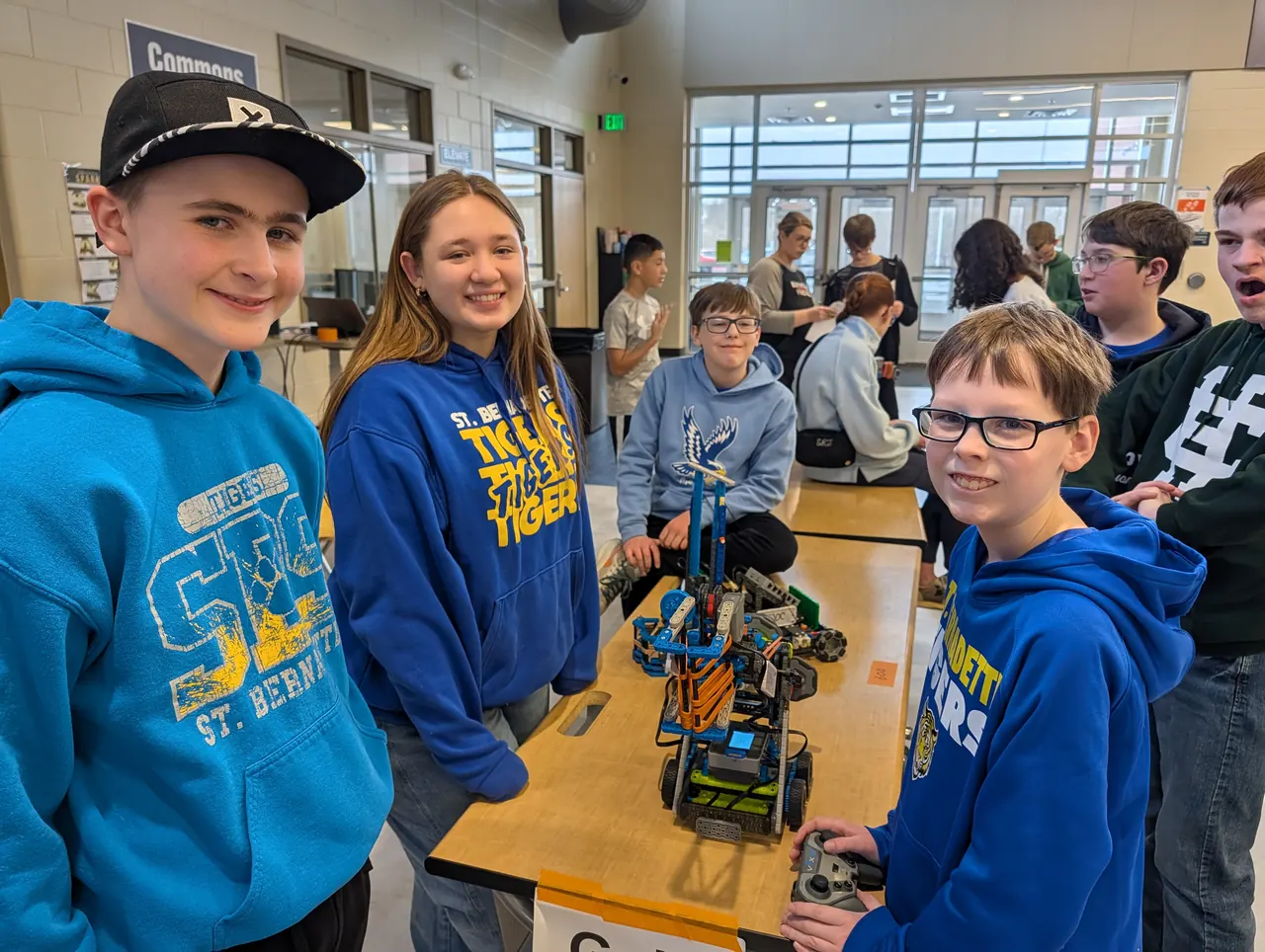 Students proudly showing their VEX IQ robot at a tournament