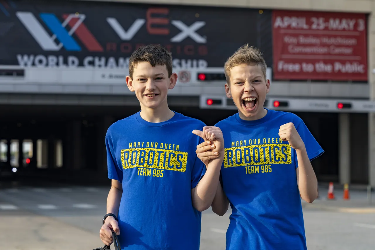 Two students celebrating outside the VEX Robotics World Championship