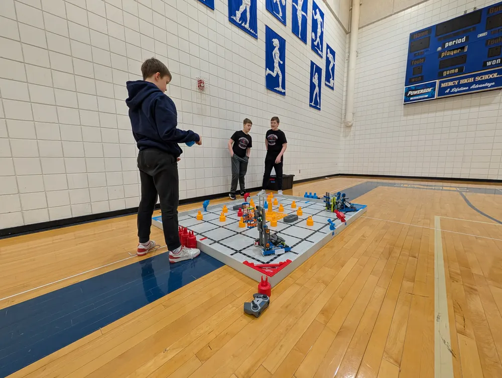 A student competing at a VEX IQ competition field during a tournament