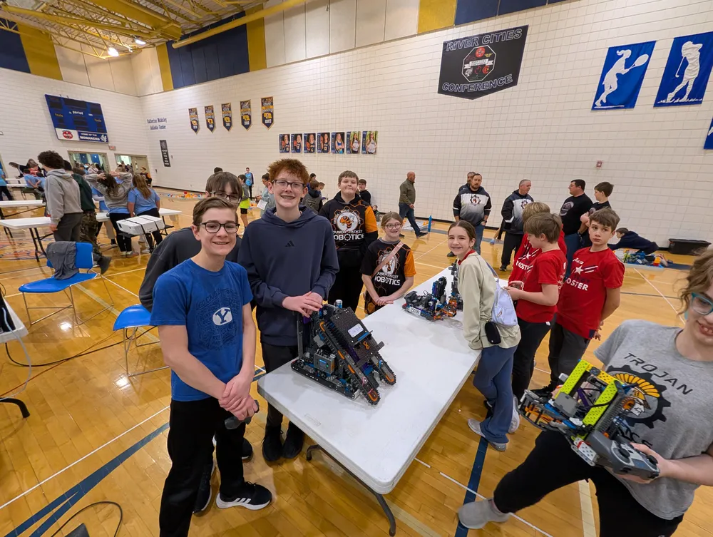 Two students presenting their VEX IQ robot at a tournament